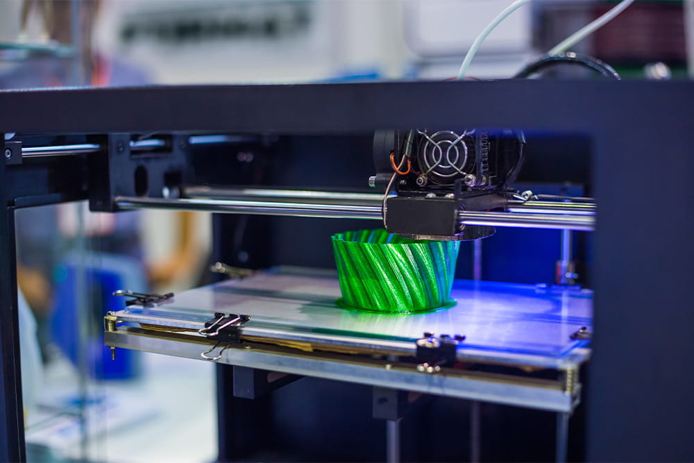 A 3D printer prints a green vessel