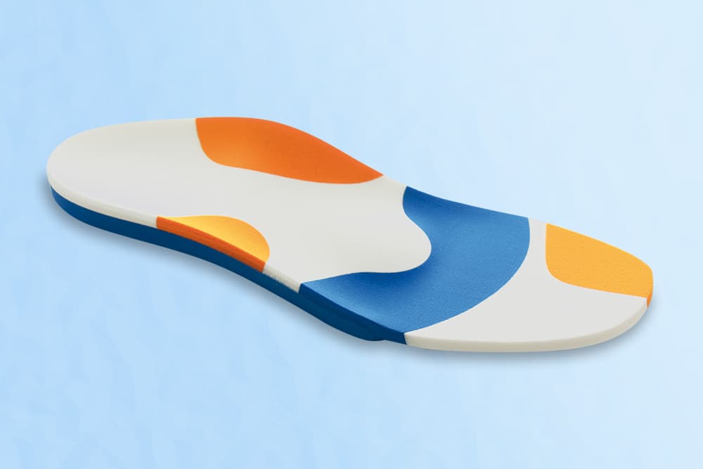 An insole with reinforced areas that are highlighted in color.